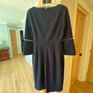 Calvin Klein navy blue dress with pearl detailing on sleeves.